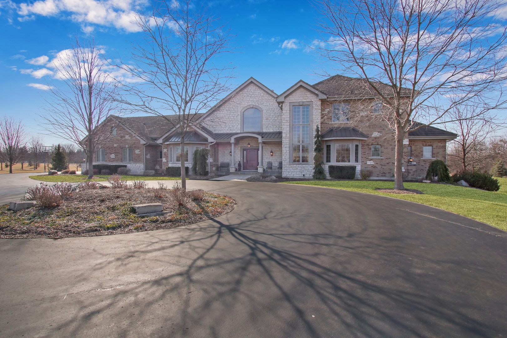 17451 Bridle Trail Road Gurnee, IL 60031 - Photo 27 of 121 a view of a large white house with a yard covered in snow
