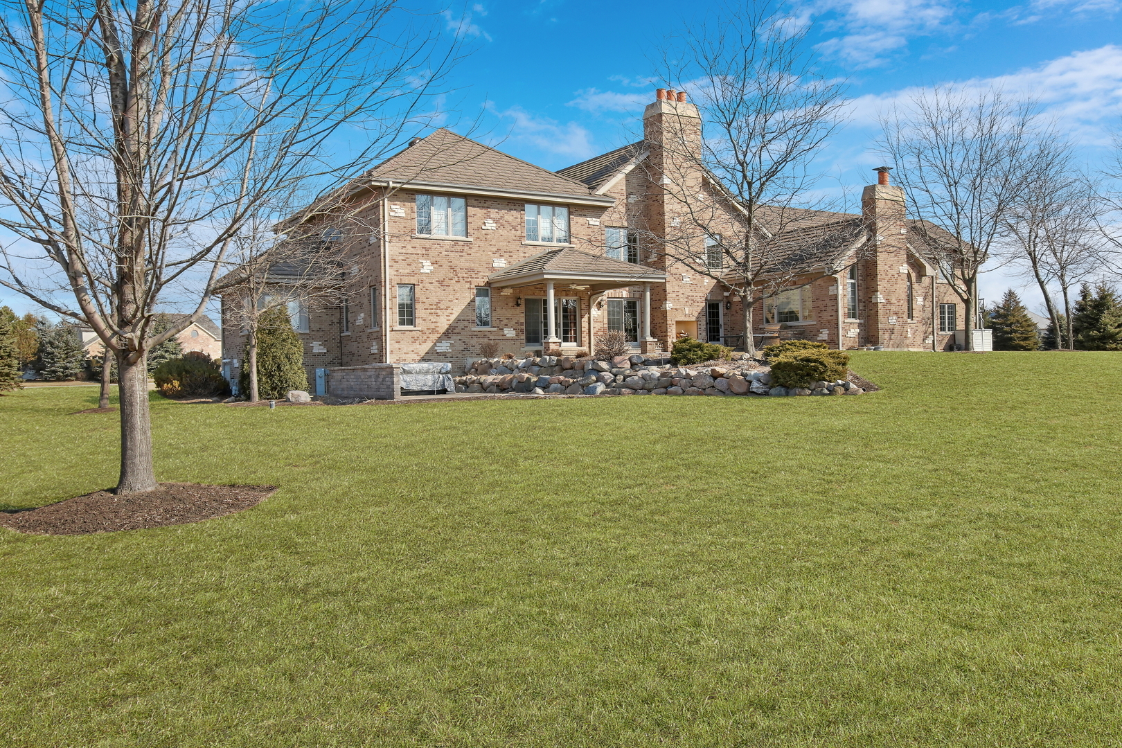 17451 Bridle Trail Road Gurnee, IL 60031 - Photo 49 of 121 a white house with a big yard and large trees