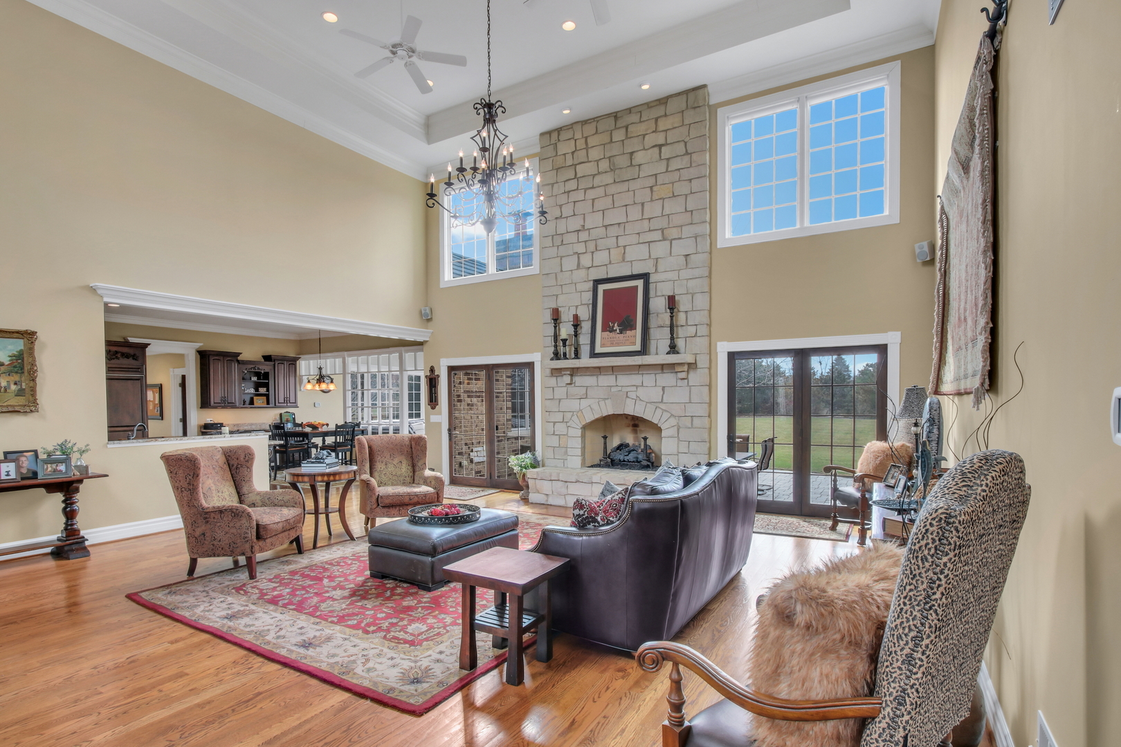 17451 Bridle Trail Road Gurnee, IL 60031 - Photo 75 of 121 a living room with furniture a fireplace and a chandelier