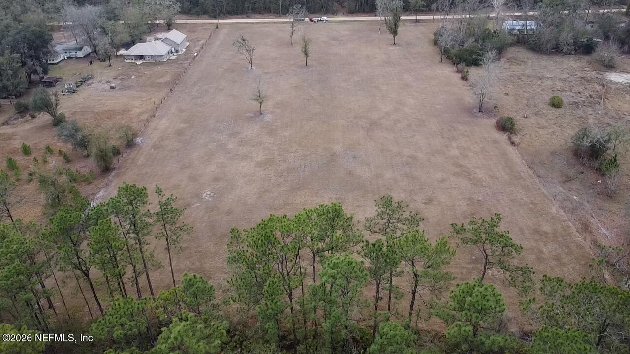 6116 Jack Wilkinson Road Jacksonville, FL 32234 - Photo 4 of 7 a view of a dry yard with trees