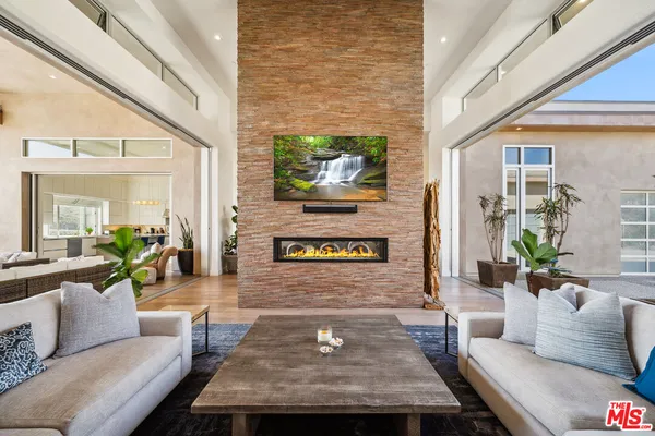 a large kitchen with kitchen island a large counter top stainless steel appliances and cabinets