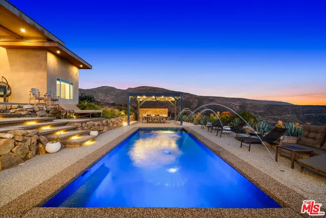 a view of a car park in front of a house