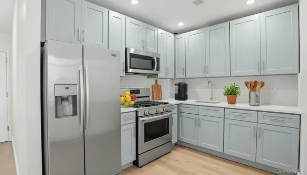a kitchen with cabinets stainless steel appliances and a counter space