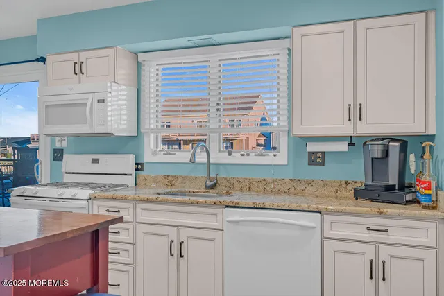 a kitchen with cabinets a counter top space and a window