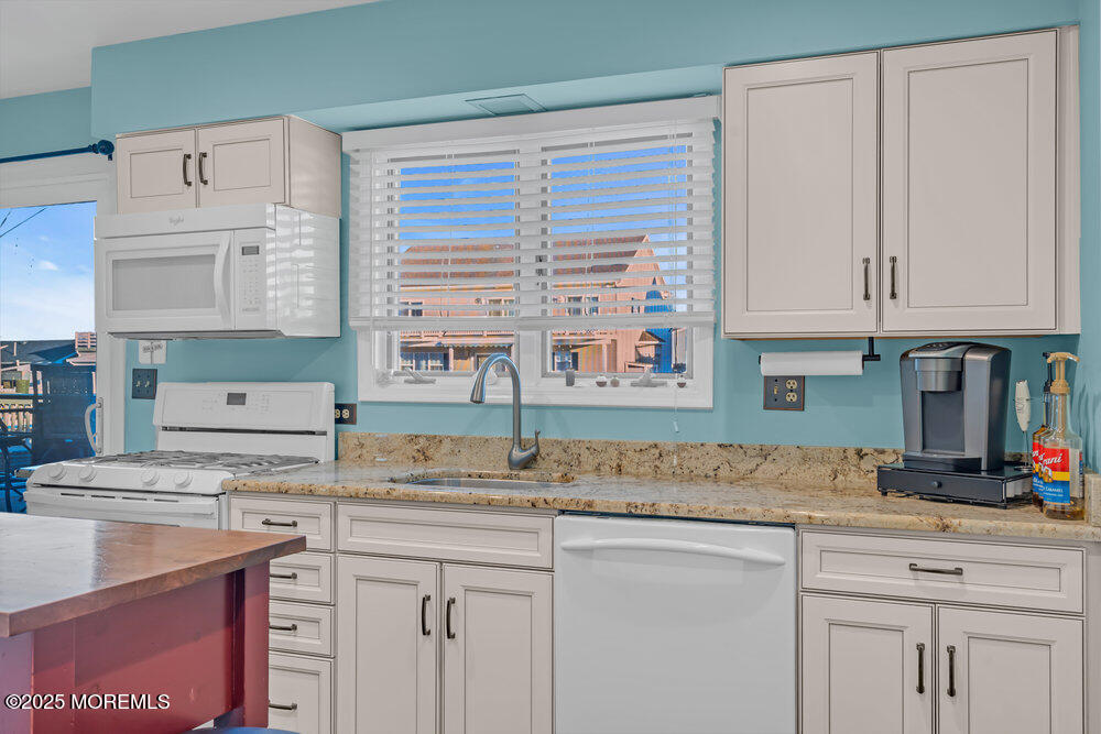 826 Forepeak Drive Forked River, NJ 08731 - Photo 14 of 56 a kitchen with stainless steel appliances granite countertop a sink a stove and white cabinets