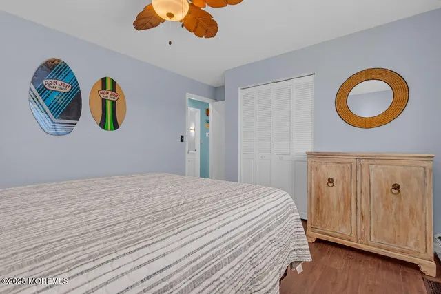 a bedroom with a bed chandelier and a window