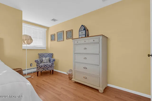 a living room with furniture a window and a flat screen tv