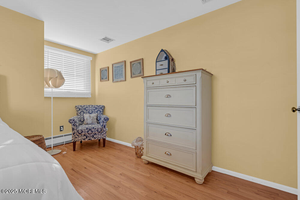 826 Forepeak Drive Forked River, NJ 08731 - Photo 27 of 56 a room with chair and a wooden floor