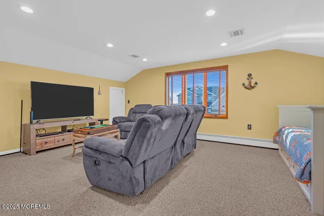 a bedroom with a bed and painting on the wall