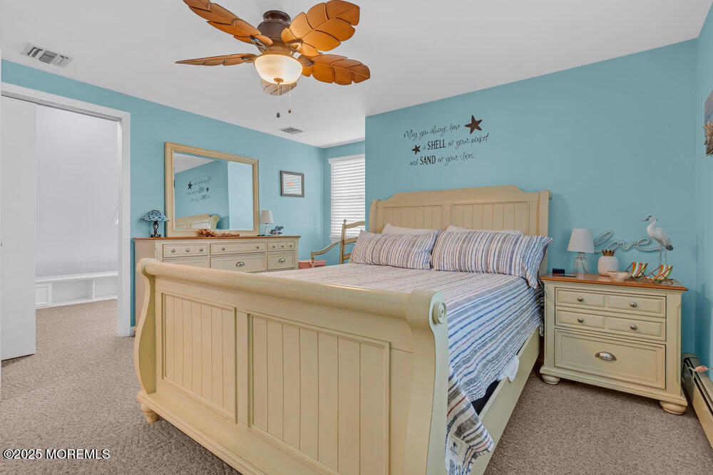 826 Forepeak Drive Forked River, NJ 08731 - Photo 33 of 56 a bedroom with a bed and a chandelier