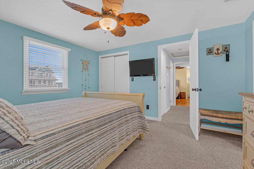 826 Forepeak Drive Forked River, NJ 08731 - Photo 34 of 56 a bedroom with a bed and a chandelier