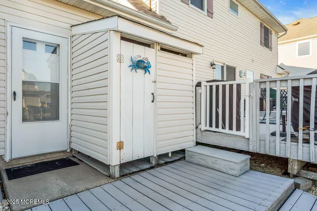 a view of a patio with table and chairs and wooden floor