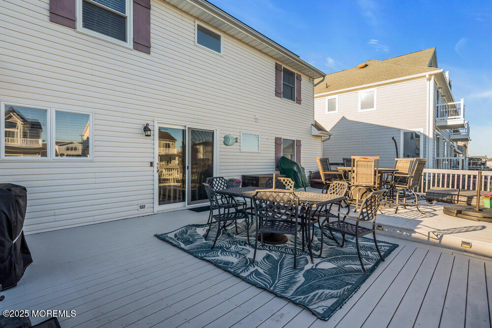 826 Forepeak Drive Forked River, NJ 08731 - Photo 43 of 56 a view of a patio with table and chairs and wooden floor