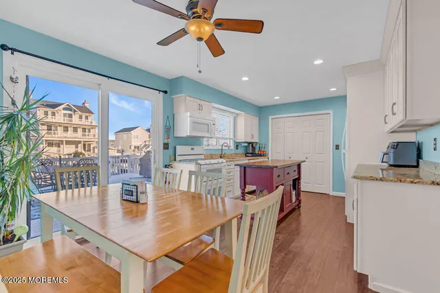 a kitchen with granite countertop a sink stove and cabinets