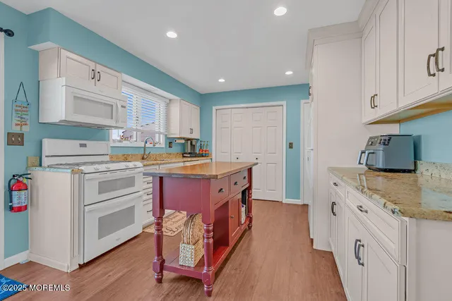 a kitchen with stainless steel appliances granite countertop a sink and cabinets