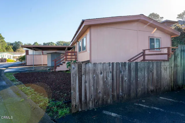 a roof deck with table and chairs and potted plants