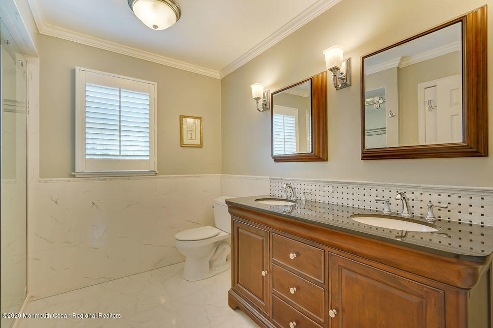 802 Wall Road Spring Lake Heights, NJ 07762 - Photo 17 of 27 a bathroom with a toilet sink and mirror