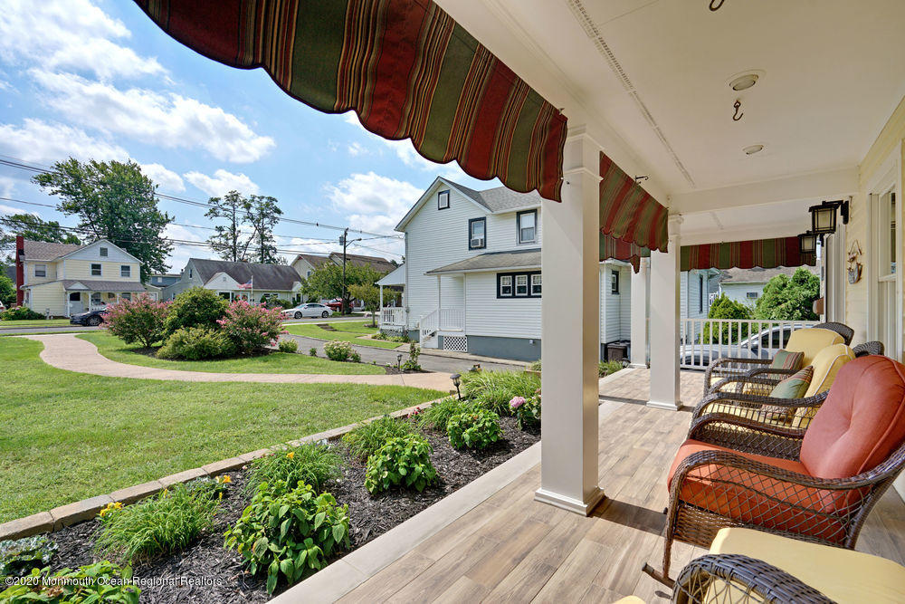 802 Wall Road Spring Lake Heights, NJ 07762 - Photo 4 of 27 a view of a patio with couches under an umbrella
