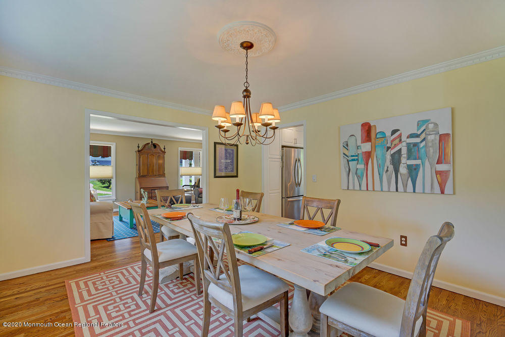 802 Wall Road Spring Lake Heights, NJ 07762 - Photo 8 of 27 a view of a dining room with furniture a chandelier and wooden floor
