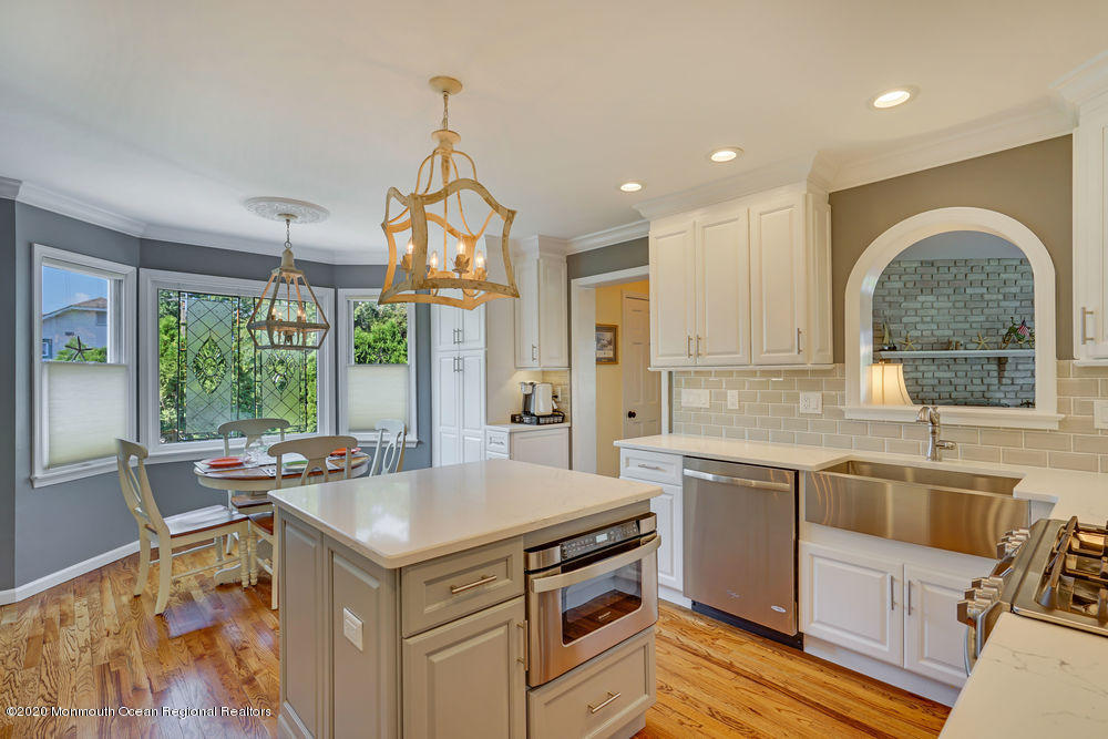802 Wall Road Spring Lake Heights, NJ 07762 - Photo 10 of 27 a kitchen with a stove a sink a counter top space and living room view