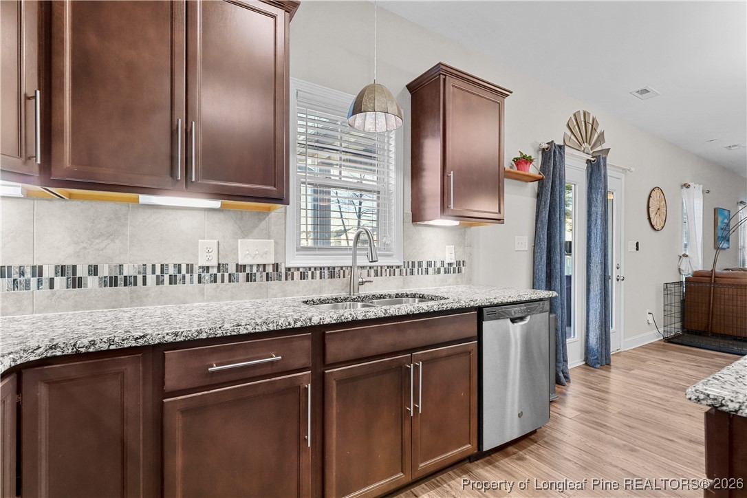 1908 Sweetfern Place Aberdeen, NC 28315 - Photo 13 of 46 a kitchen with granite countertop stainless steel appliances sink and microwave