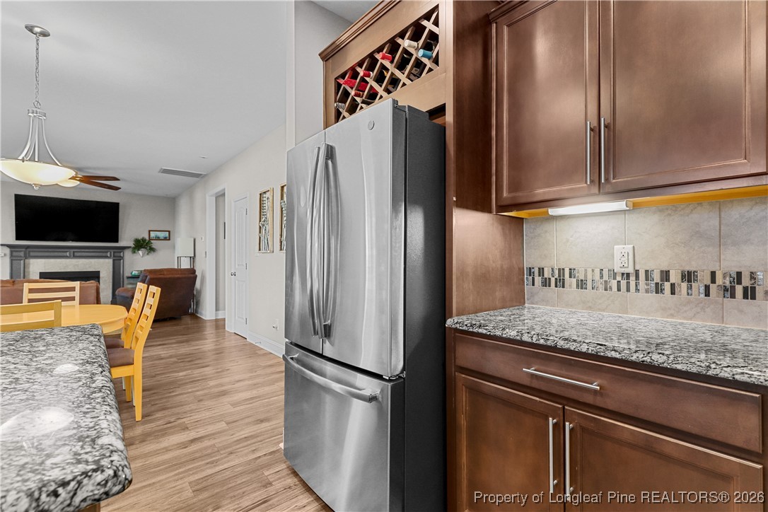 1908 Sweetfern Place Aberdeen, NC 28315 - Photo 14 of 46 a kitchen with granite countertop a refrigerator and a stove top oven