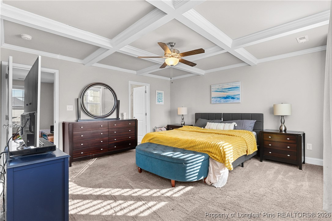 1908 Sweetfern Place Aberdeen, NC 28315 - Photo 19 of 46 a bedroom with a bed mirror on dresser and a chandelier