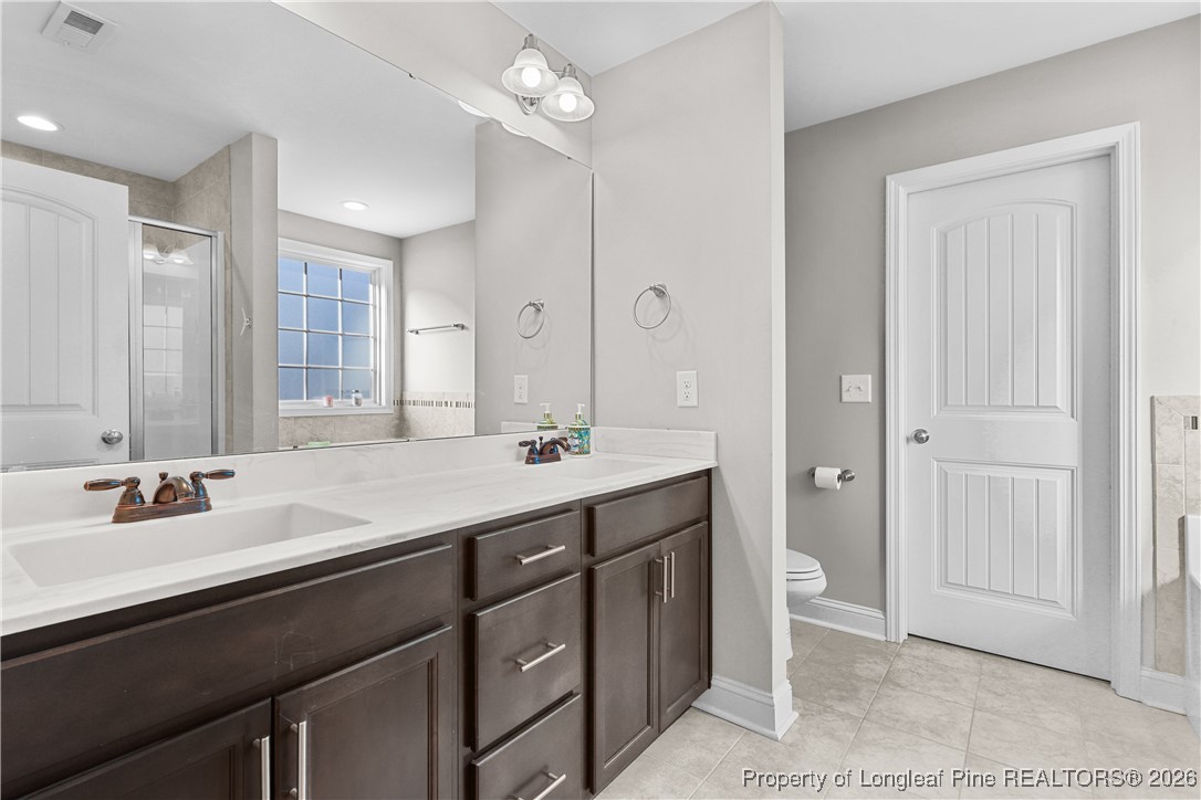 1908 Sweetfern Place Aberdeen, NC 28315 - Photo 21 of 46 a bathroom with a sink double vanity and a mirror