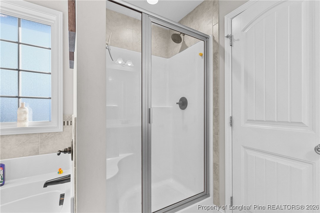 1908 Sweetfern Place Aberdeen, NC 28315 - Photo 23 of 46 a bathroom with a bathtub and a shower