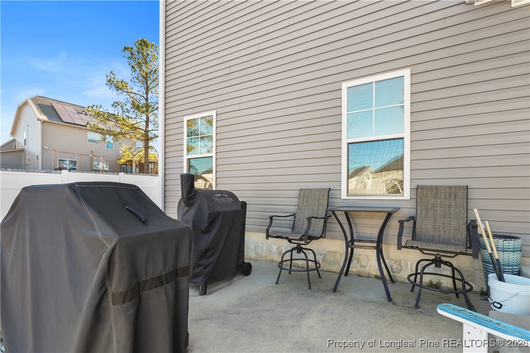 1908 Sweetfern Place Aberdeen, NC 28315 - Photo 33 of 46 a view of a patio with table and chairs with wooden floor and plants