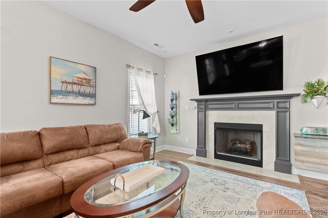 1908 Sweetfern Place Aberdeen, NC 28315 - Photo 4 of 46 a living room with furniture a flat screen tv and a fireplace