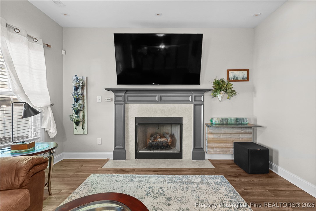 1908 Sweetfern Place Aberdeen, NC 28315 - Photo 5 of 46 a living room with furniture and a fireplace