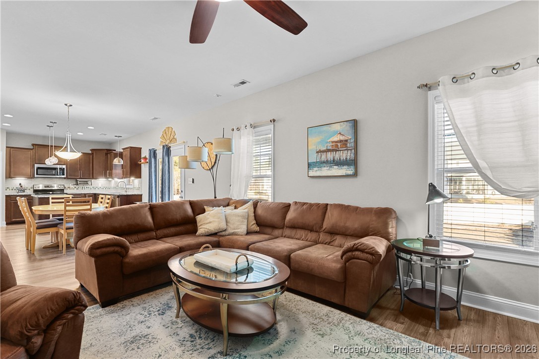 1908 Sweetfern Place Aberdeen, NC 28315 - Photo 6 of 46 a living room with furniture a rug potted plant and a large window