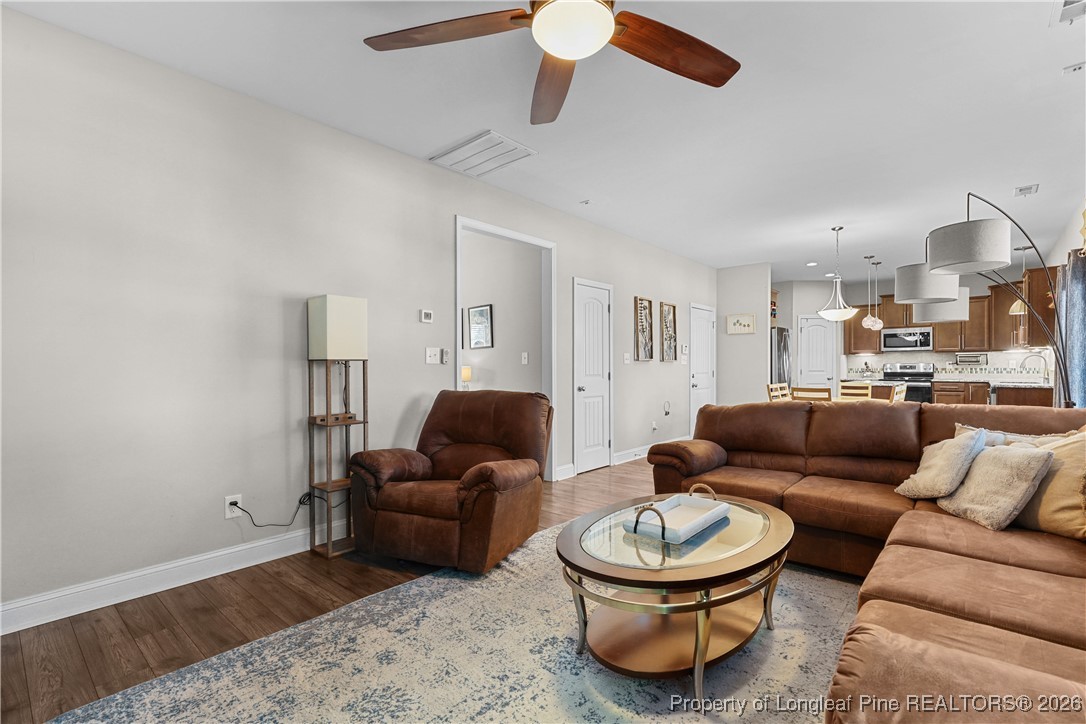 1908 Sweetfern Place Aberdeen, NC 28315 - Photo 7 of 46 a living room with furniture and a rug
