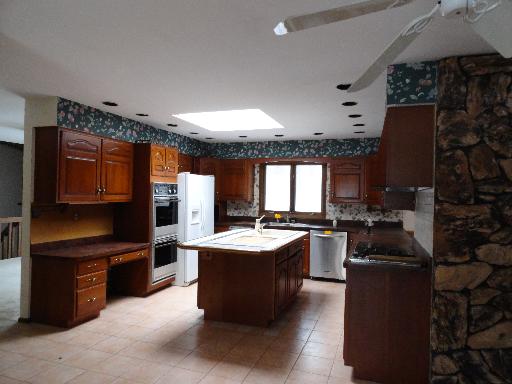 33W662 Hub Road Wayne, IL 60174 - Photo 4 of 16 a kitchen with a sink stove and refrigerator