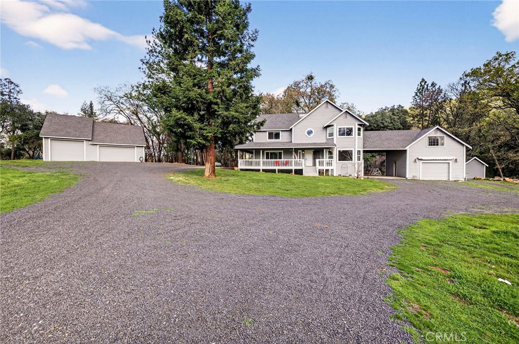a front view of a house with a yard and trees