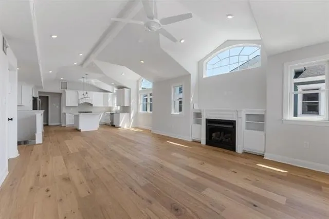 a view of kitchen and hall with wooden floor