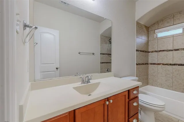 a bathroom with a sink vanity granite toilet tub and shower