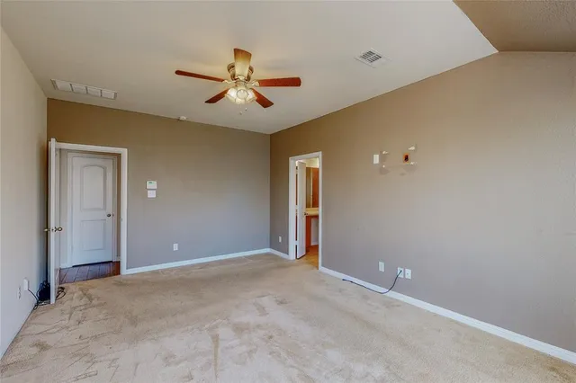 a view of a livingroom with a ceiling fan and window