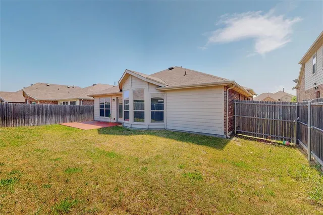 a view of a house with swimming pool and a yard