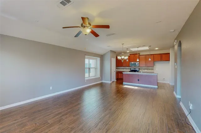 a view of kitchen and hall with wooden floor