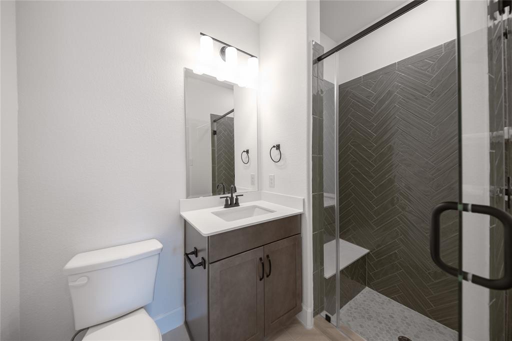2719 Triumph Court Heath, TX 75126 - Photo 3 of 39 a bathroom with a toilet sink and mirror