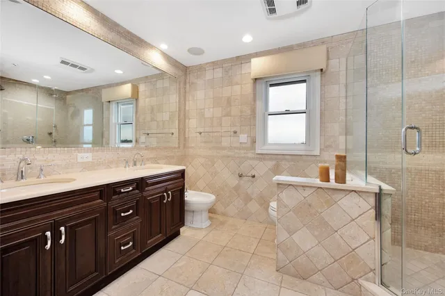 a bathroom with a granite countertop sink mirror and bathtub