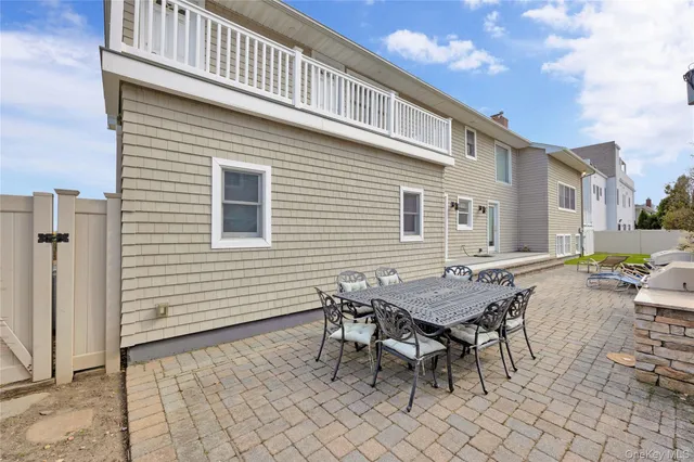 a view of a dinning table and chairs in backyard of the house