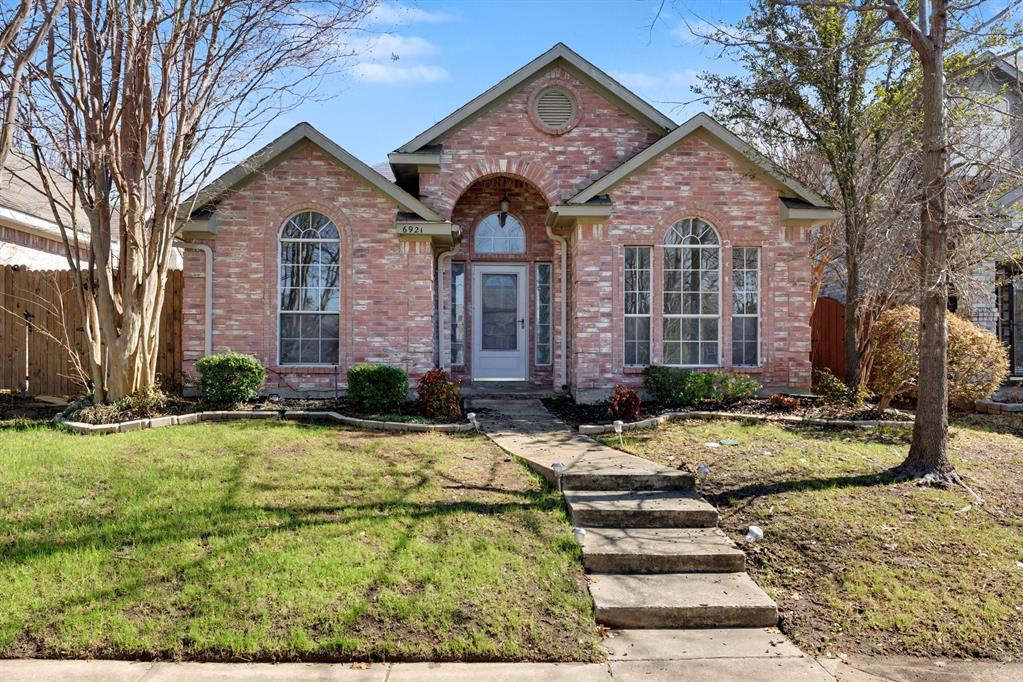 6921 Hominy Ridge Rowlett, TX 75089 - Photo 1 of 27 a front view of a house with garden