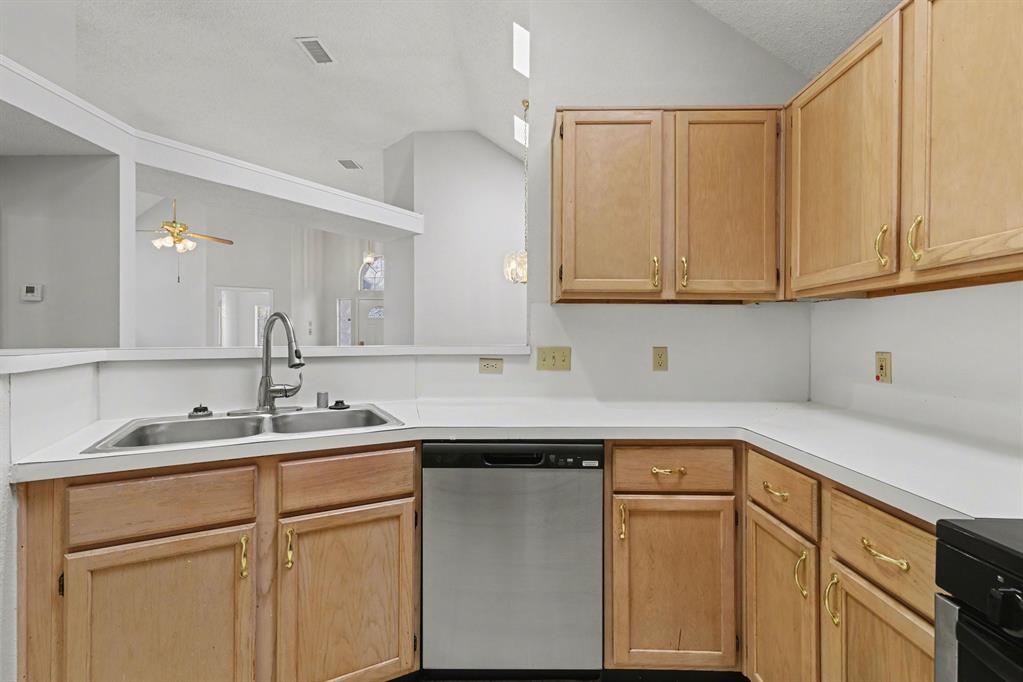 6921 Hominy Ridge Rowlett, TX 75089 - Photo 11 of 27 a kitchen with a sink and cabinets