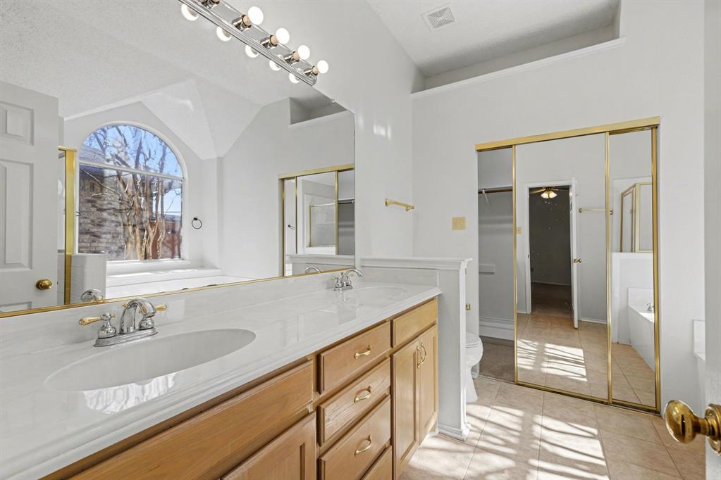 6921 Hominy Ridge Rowlett, TX 75089 - Photo 15 of 27 a bathroom with a sink double vanity and a mirror
