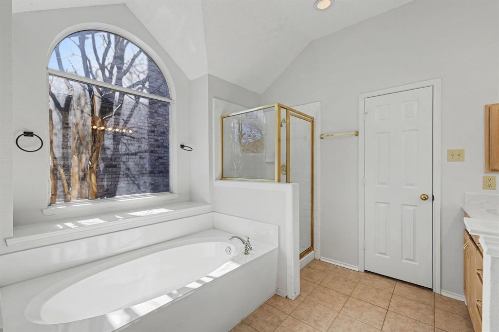 6921 Hominy Ridge Rowlett, TX 75089 - Photo 16 of 27 a bathroom with a bathtub and a shower