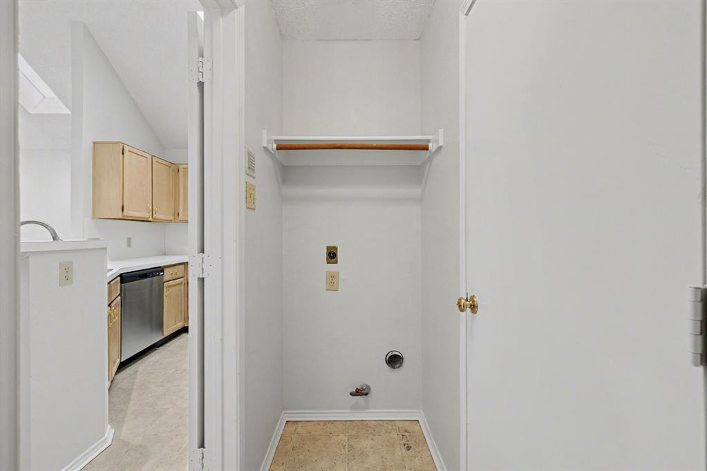 6921 Hominy Ridge Rowlett, TX 75089 - Photo 18 of 27 a kitchen with a refrigerator and cabinets