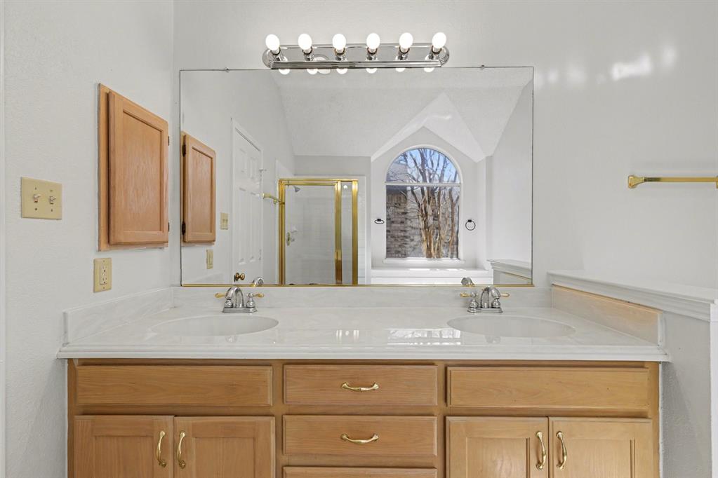 6921 Hominy Ridge Rowlett, TX 75089 - Photo 22 of 27 a bathroom with a sink double vanity and a mirror